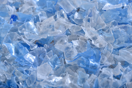 Flakes of crushed plastic bottles as raw material for further processing.