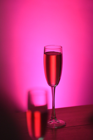 The table in the restaurant. A glass of pink champagne close-up.の写真素材