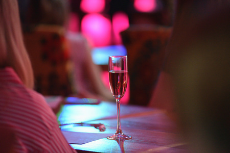 The table in the restaurant. A glass of pink champagne close-up.の写真素材