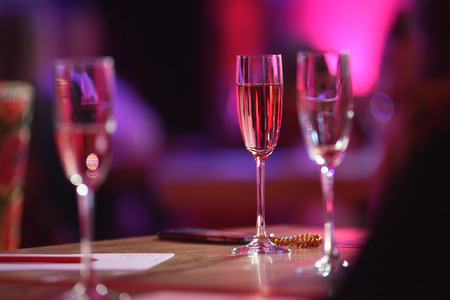 The table in the restaurant. A glass of pink champagne close-up.の写真素材