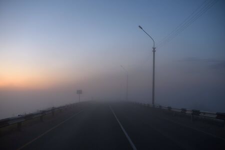 Midnight car track covered with fog