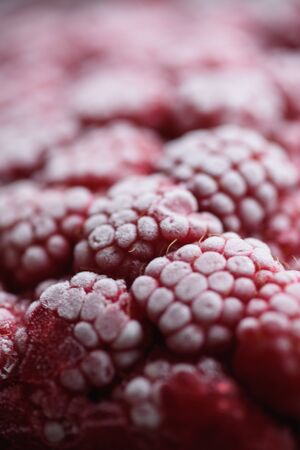 Food background. Freshly frozen raspberries, turned into a juicy piece of ice during freezing.の写真素材