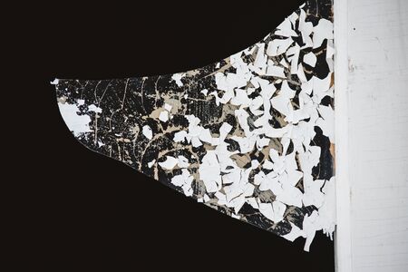 A broken window pane in the doorway, with sharp, dangerous edges of splinters and peeling paint.の写真素材