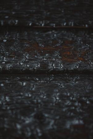 Charred wooden plank wall. Background close-up. Texture.の写真素材