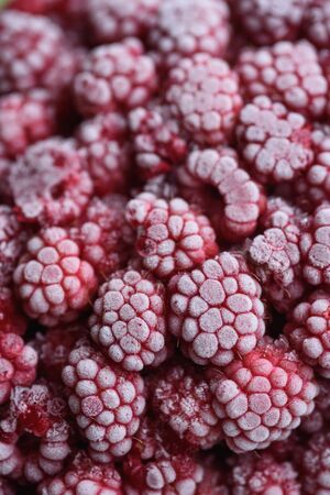 Food background. Freshly frozen raspberries, turned into a juicy piece of ice during freezing.の写真素材