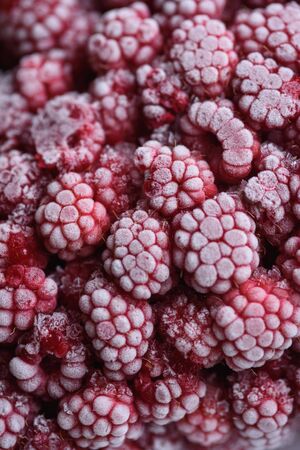 Food background. Freshly frozen raspberries, turned into a juicy piece of ice during freezing.の写真素材