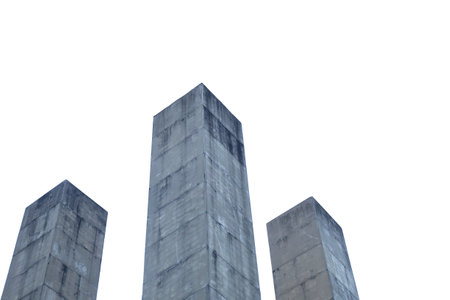 A group of high cement towers with grid pattern on white sky backgroundの写真素材