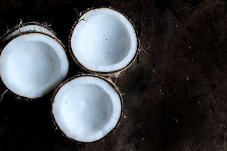 A group of a half cut of coconuts on old aluminium table