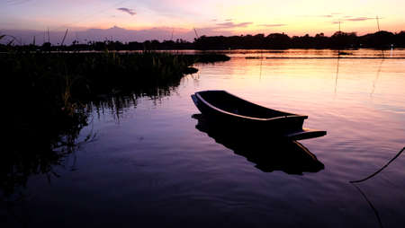 Silhouette of a boat on the lake in the evening.