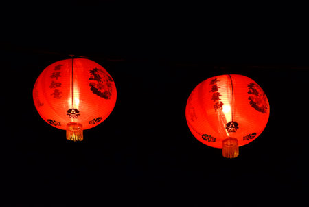 A Of Chinese lantern hanging on a wire and shinning in the dark night for Chinese New year...