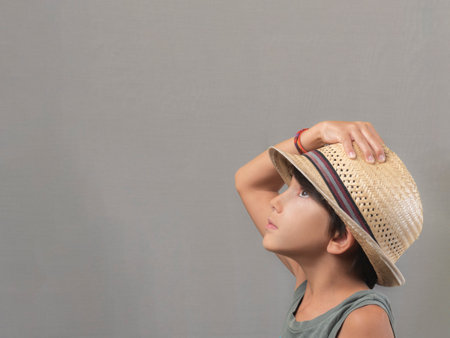 Boy in a straw hat with a blank stare.の写真素材