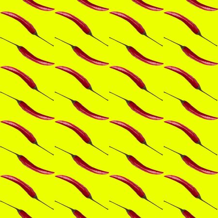 Red  chilli pepper on yellow background, flat lay, top view, pattern.の写真素材
