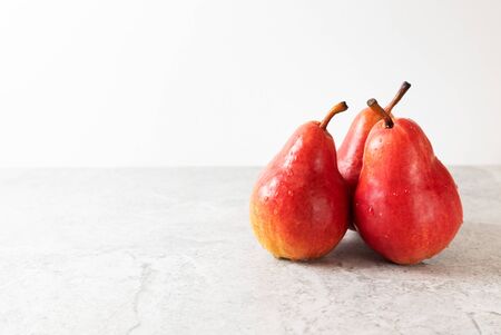 Three red pears on a light backgroundの写真素材