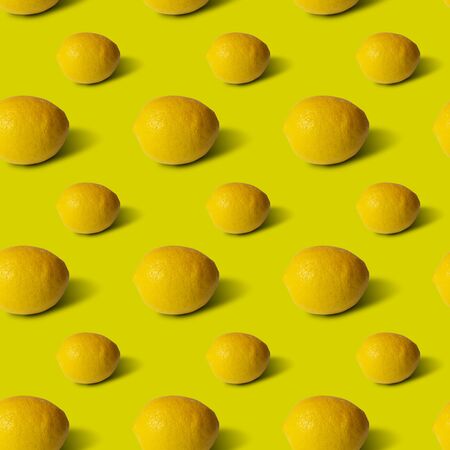 Lemons on yellow background, flat lay, top view, pattern.の写真素材