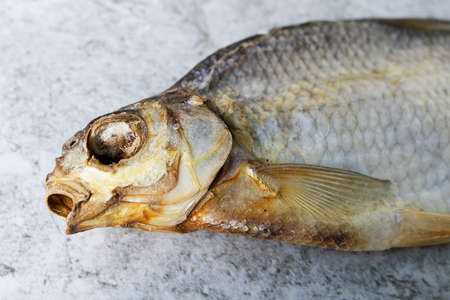 Dried salted fish on a concrete background. Homemade food, beer snack.の写真素材