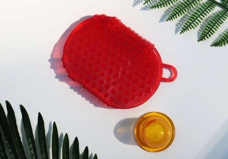Yellow vacuum massage jar and red silicone massage brush on a white background.の写真素材