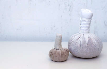 Herbal bags for spa massage on table.の写真素材