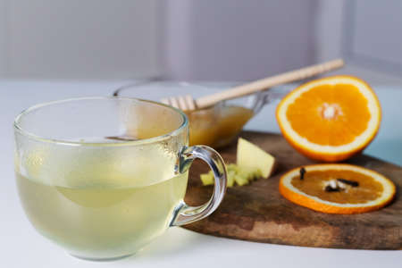 Herbal warming tea with ginger, honey and orange.の写真素材