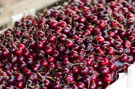 A box of ripe cherries in a grocery store.の写真素材