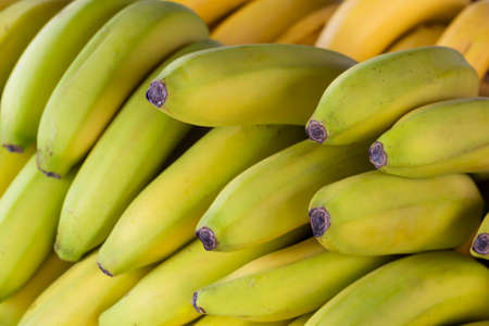 Ripe bananas on the counter in a grocery storeの写真素材