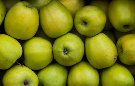 Ripe green apples on the counter in a grocery storeの写真素材