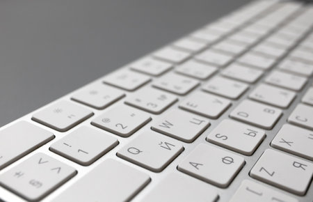 The wireless keyboard is white on a gray background with a place for text. English-Russian layout.の写真素材