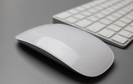 Wireless keyboard and mouse in white on a gray background. English-Russian letter layout.