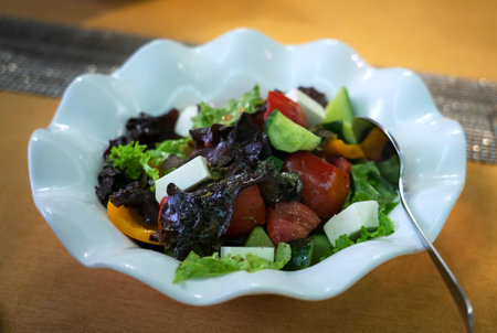 Freshly prepared Greek salad in a white plateの写真素材