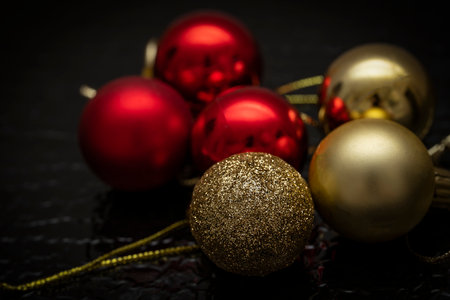 Christmas balls of red and gold color on a black background. Christmas background, screensaver. high quality photoの写真素材