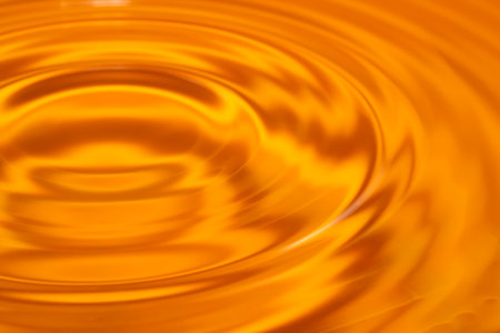 Circles on the water. Yellow, golden background. high quality photoの写真素材
