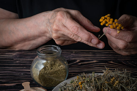 Dried medicinal herb, antiparasitic collection of tansy, wormwood and cloves (troychatka). The herbalist is preparing herbal tea. high quality photoの写真素材