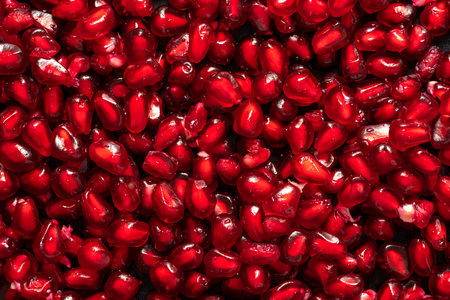 Ripe pomegranate grains. Fruit red background. high quality photoの写真素材