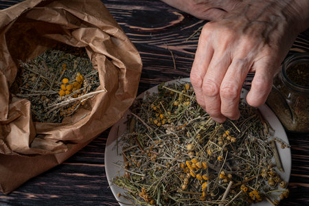 Dried medicinal herb, antiparasitic collection of tansy, wormwood and cloves (troychatka). The herbalist is preparing herbal tea. high quality photoの写真素材