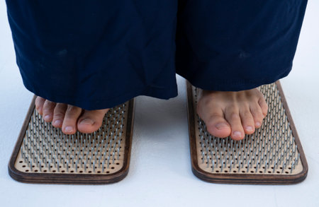 Feet close-up on a board with nails. Nailing on boards of sadhus. high quality photoの写真素材