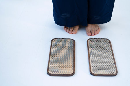 The girl is preparing to stand on the board with nails. Nailing on boards of sadhus. high quality photoの写真素材