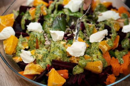 Ready-made grilled beetroot, pumpkin, orange, cream cheese salad. high quality photoの写真素材