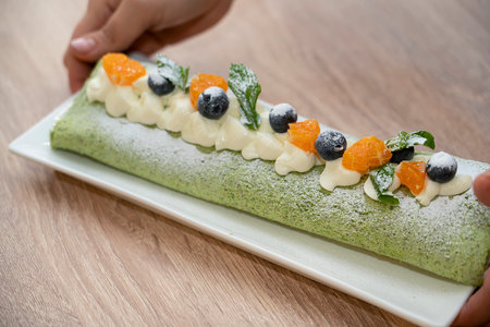 Master class on cooking desserts. Ready pistachio roll close-up. high quality photoの写真素材