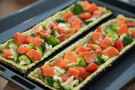 Quiche with salmon, broccoli and tomatoes before baking. Cooking a pie. high quality photoの写真素材