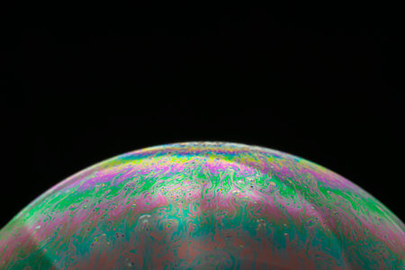 Rainbow soap bubble on a black background close-up. high quality photoの写真素材