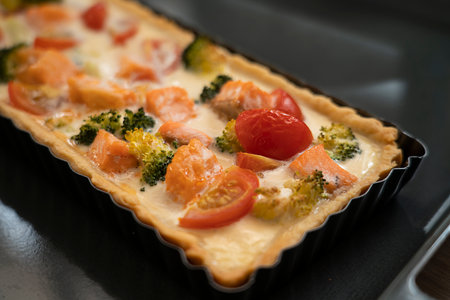 Ready-made quiche with salmon, broccoli and tomatoes. Cooking a pie. high quality photoの写真素材