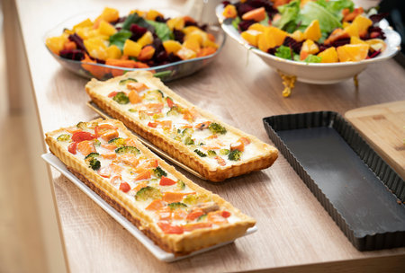 Ready-made quiche with salmon, broccoli and tomatoes. Cooking a pie. high quality photoの写真素材