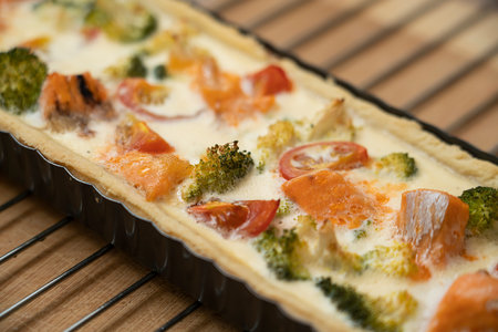 Ready-made quiche with salmon, broccoli and tomatoes. Cooking a pie. high quality photoの写真素材