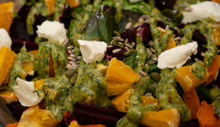 Ready-made grilled beetroot, pumpkin, orange, cream cheese salad. high quality photoの写真素材