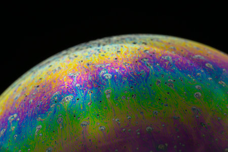 Rainbow soap bubble on a black background close-up. high quality photoの写真素材