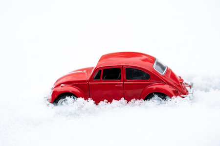 Red toy retro car on the snow. Background, postcard with place for text. high quality photoの写真素材
