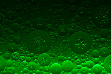 Green abstract, texture background of oil bubbles on water. Space background for screen saver, cover, wallpaper. high quality photoの写真素材