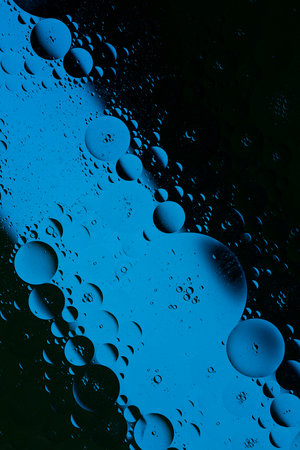 Blue abstract, texture background of oil bubbles on water. Space background for screen saver, cover, wallpaper. high quality photoの写真素材
