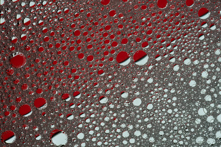 Abstract texture background in red. Circles of oil in soapy water. high quality photoの写真素材