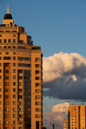 Nursultan, Kazakhstan, August 2022. The roof of a tall yellow house against a blue sky with clouds. high quality photoの写真素材