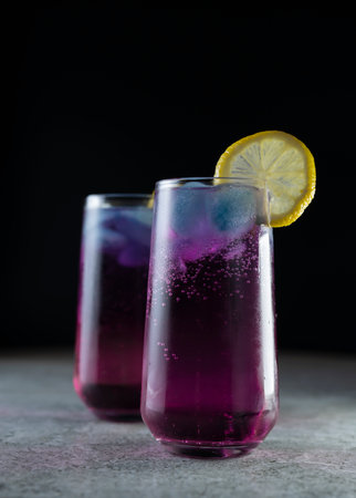 Bright refreshing cocktail. Pink lemonade with blue ice cubes. Galaxy lemonade. high quality photo